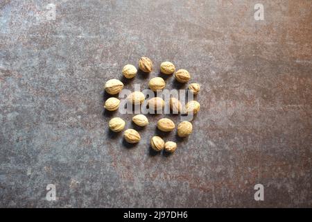 Raw whole dried seed of Terminalia bellirica fruit Stock Photo