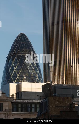 Tower 42 (R) with 30 Saint Mary Axe (L) informally known as the Gherkin are commercial skyscrapers in the City of London, London's primary financial d Stock Photo