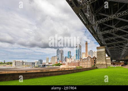 Sydney, Australia - April 16, 2022: Sydney central business district viewed from under the Harbour bridge on a cloudy day Stock Photo