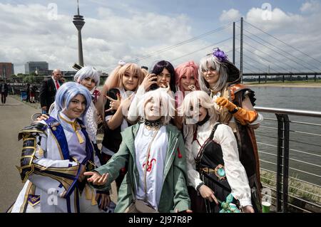 Duesseldorf, Germany. 21st May, 2022. Dressed-up young people take part in Japan Day on the banks of the Rhine. Since 1983, the Japanese have honored their traditionally good relations with North Rhine-Westphalia and especially with the city of Düsseldorf with Japan Weeks. The festival is always attended by thousands of imaginatively dressed-up young people, including 'cosplay' fans. Credit: Bernd Thissen/dpa/Alamy Live News Stock Photo
