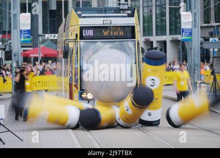 Leipzig, Germany. 21st May, 2022. A streetcar with a driver from Vienna drives a ball into bowling pins set up for the European Tram Championships on Augustusplatz. The action is one of seven disciplines in the competition, which pits 25 teams from 19 countries against each other. Credit: Sebastian Willnow/dpa/Alamy Live News Stock Photo