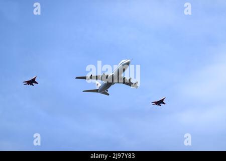 MOSCOW, RUSSIA - MAY 7, 2022: Doomsday plane Il-80 (Maxdome) escorted by two fighter jets flies over Moscow at a parade rehearsal in blue sky Stock Photo