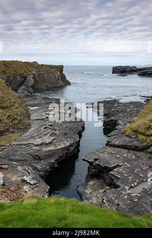 Rugged coast on the Wild Atlantic Way at Bridges of Ross, County Clare, Ireland Stock Photo