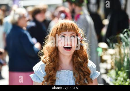 Brighton UK 21st May 2022 - Crowds enjoy the sunshine in Brighton's North Laine area today as the warm weather is forecast to continue over the weekend : Credit Simon Dack / Alamy Live News Stock Photo