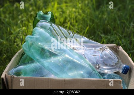Plastic bottles and bottle caps on grass. Stock Photo