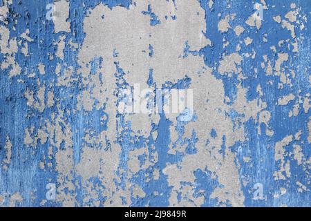 Old Damaged metallic Surface with Peeling Paint Pieces. Stock Photo
