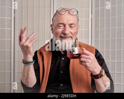 casual portrait of happy and smiling senior man drinking tea Stock Photo