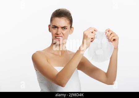 Beautiful woman surprising with facial mask sheet on white background Stock Photo