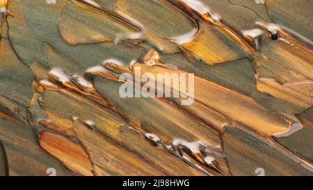 Green-orange glitter textured background. Creative brushstrokes of glitter gold paint. Sparkling surface of green gold paint strokes Stock Photo