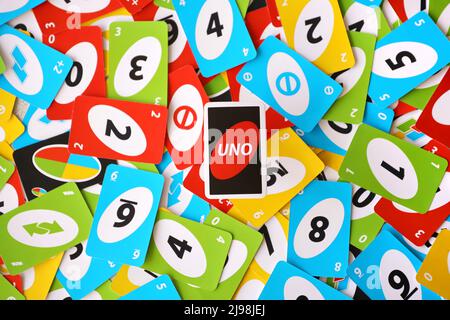 TERNOPIL, UKRAINE - MAY 15, 2022: Many colorful UNO game cards. UNO is an American shedding-type card game that is played with a specially printed dec Stock Photo