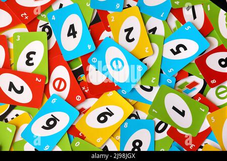 TERNOPIL, UKRAINE - MAY 15, 2022: Many colorful UNO game cards. UNO is an American shedding-type card game that is played with a specially printed dec Stock Photo