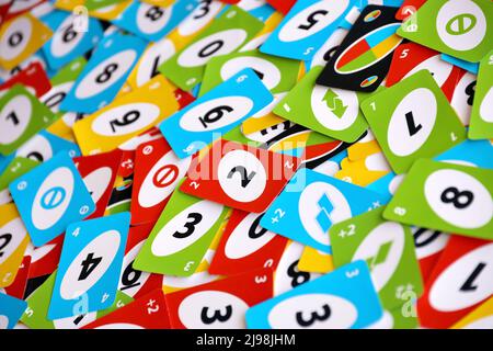 TERNOPIL, UKRAINE - MAY 15, 2022: Many colorful UNO game cards. UNO is an American shedding-type card game that is played with a specially printed dec Stock Photo