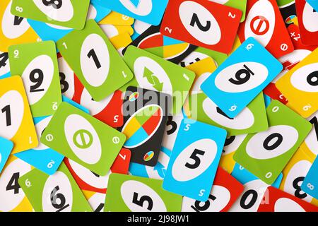 TERNOPIL, UKRAINE - MAY 15, 2022: Many colorful UNO game cards. UNO is an American shedding-type card game that is played with a specially printed dec Stock Photo