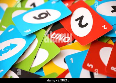 TERNOPIL, UKRAINE - MAY 15, 2022: Many colorful UNO game cards. UNO is an American shedding-type card game that is played with a specially printed dec Stock Photo