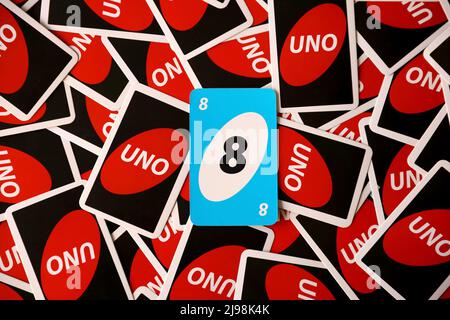 TERNOPIL, UKRAINE - MAY 15, 2022: Many colorful UNO game cards. UNO is an American shedding-type card game that is played with a specially printed dec Stock Photo