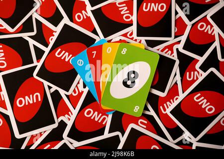 TERNOPIL, UKRAINE - MAY 15, 2022: Many colorful UNO game cards. UNO is an American shedding-type card game that is played with a specially printed dec Stock Photo