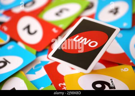 TERNOPIL, UKRAINE - MAY 15, 2022: Many colorful UNO game cards. UNO is an American shedding-type card game that is played with a specially printed dec Stock Photo