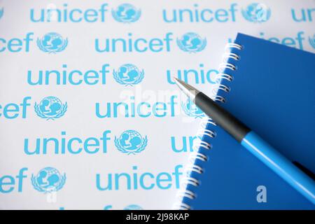 TERNOPIL, UKRAINE - MAY 2, 2022: Blue notepad and pen from UNICEF - United Nations programm that provides humanitarian and developmental assistance to Stock Photo