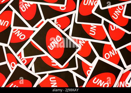 TERNOPIL, UKRAINE - MAY 15, 2022: Many colorful UNO game cards. UNO is an American shedding-type card game that is played with a specially printed dec Stock Photo