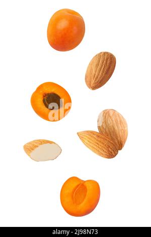 Cut apricot and almond isolated on white background with clipping path Stock Photo