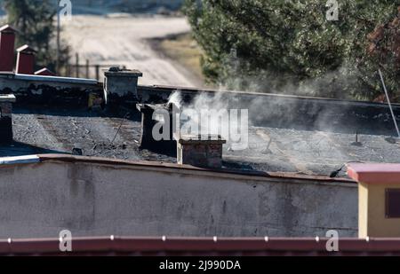 Chimney on the roof of the building. Vent and smoke chimney, smoke outlet. Stock Photo