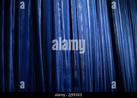 Blue Curtain. Fabric in folds. Blue cloth made of heavy fabric. Background concert curtain. Stock Photo