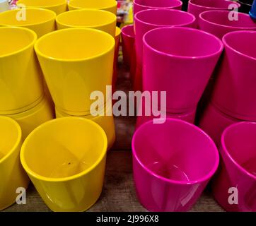 A stack of decorative yellow and pink flower pots Stock Photo
