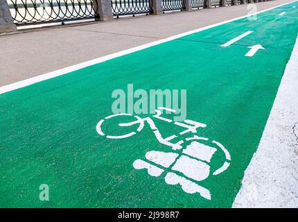 Dedicated bicycle lane with bicycle and roller skates sign, designed to make cycling safer on the asphalt road Stock Photo