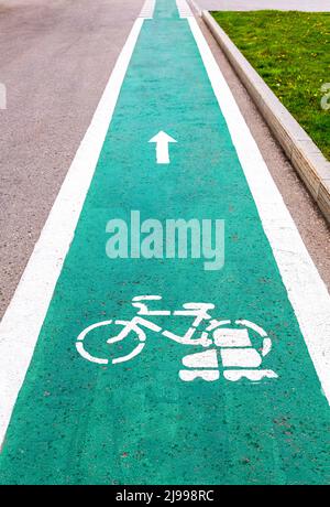 Dedicated bicycle lane with bicycle and roller skates sign, designed to make cycling safer on the asphalt road Stock Photo