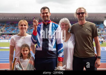 Birmingham, England. 21st May, 2022. Robbie Grabarz, with family, of Team GB receives a silver medal for the London 2012 High Jump following Ivan Ukhov being stripped of the gold medal at the Müller Diamond League athletics event at the Alexander Stadium in Birmingham, England. Credit: Sporting Pics / Alamy Live News Stock Photo