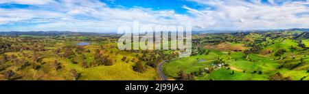 Scenic wide aerial panorama of Bega Valley green pasture meadows on dairy farms, Australian agriculture. Stock Photo