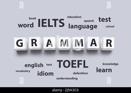 Text GRAMMAR made of cubes and different words on grey background. Concept of studying English Stock Photo