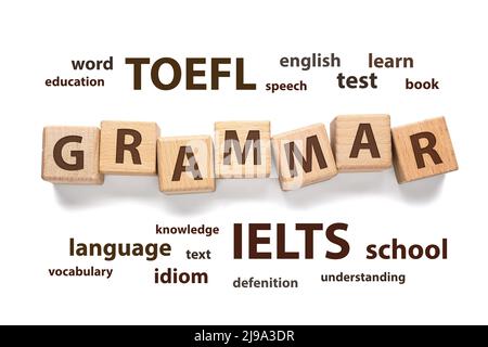 Text GRAMMAR made of wooden cubes and different words on white background. Concept of studying English Stock Photo