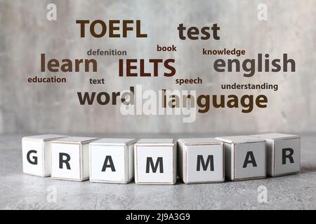 Text GRAMMAR made of cubes and different words on light background. Concept of studying English Stock Photo