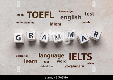 Text GRAMMAR made of cubes and different words on light background. Concept of studying English Stock Photo