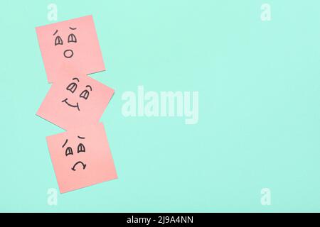 Sticky notes with different smile drawings on color background Stock Photo