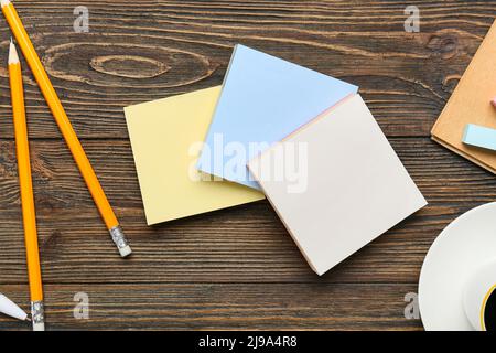 Blank sticky notes and pencils on wooden background, closeup Stock Photo