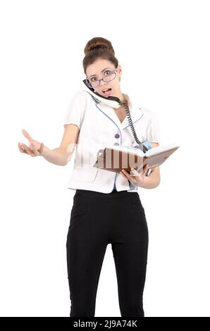 A young girl writes in notebook secretary telephone conversation. Isolated on white Stock Photo