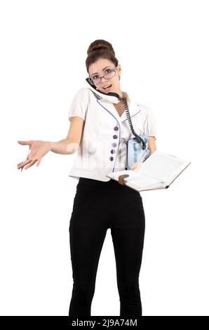 A young girl writes in notebook secretary telephone conversation. Isolated on white Stock Photo