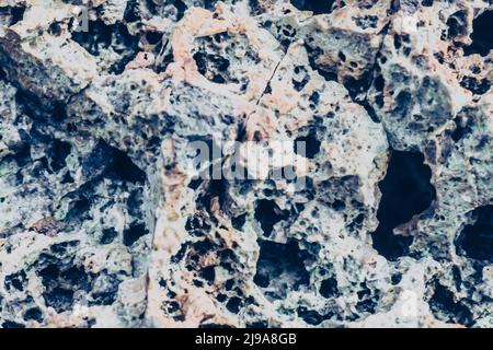 Abstract nature real photo background. Macro close up details dry rock crack stone solid foamy formations or lava volcanic, pumice texture ancient Stock Photo
