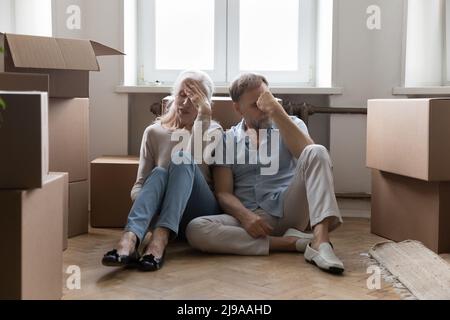 Elder couple of homeowners exhausted with relocation Stock Photo