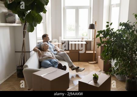 Happy retired couple taking break from moving into new flat Stock Photo