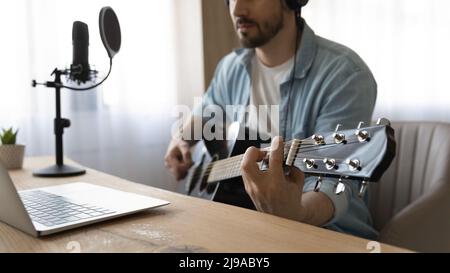 Young man play guitar use recording music equipment and software Stock Photo