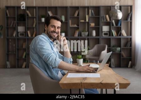 Portrait of young man work at home office by pc Stock Photo