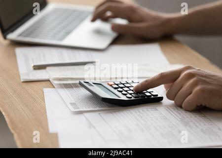 Young male accounting clerk filling in tax declaration electronic form Stock Photo