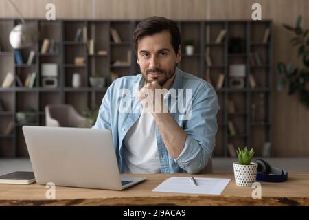 Young man professional expert freelancer do remote job at workplace Stock Photo