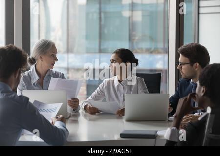 Businesspeople make project sales stats review at meeting in office Stock Photo