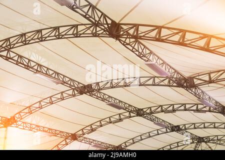 Arched metal frame tent with white coated fabric material, with interior lighting lamps Stock Photo