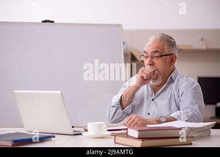 Old businessman employee working from home during pandemic Stock Photo