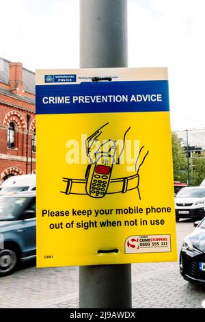 A crime prevention poster warns of phone theft. The mobile phone and belt clip in the illustration are old fashioned and no longer popular. London, UK Stock Photo